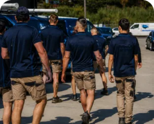 Plumbers walking to their service vans on a Coogee job